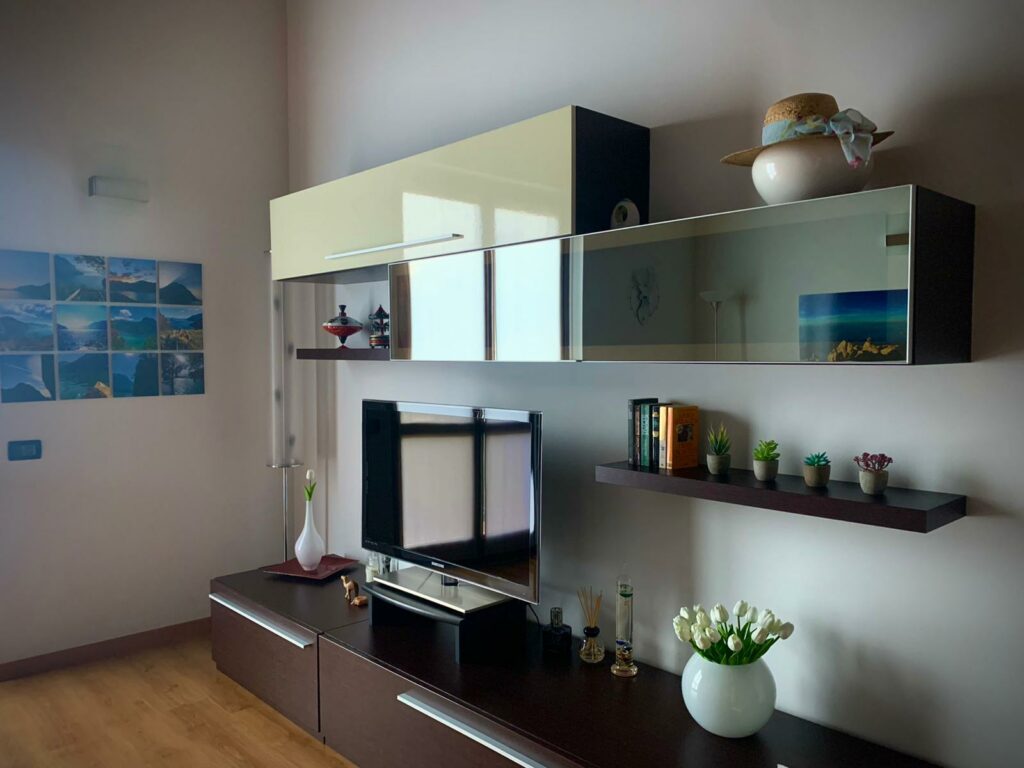 Cozy and chic living room in La Rocca, featuring artistic wall decorations and modern furniture
